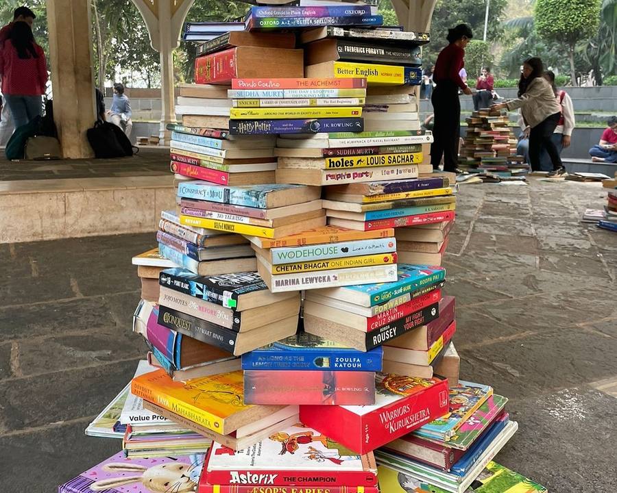 A tower of donated books at a Library Building Drive