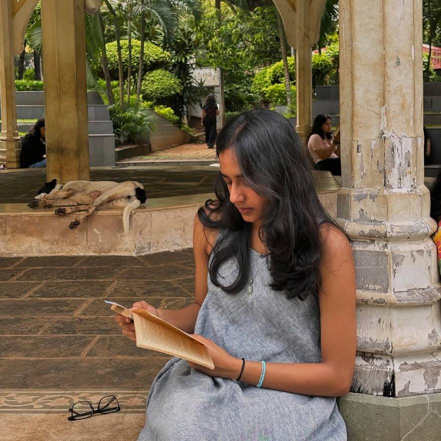 A reader under heritage stone columns