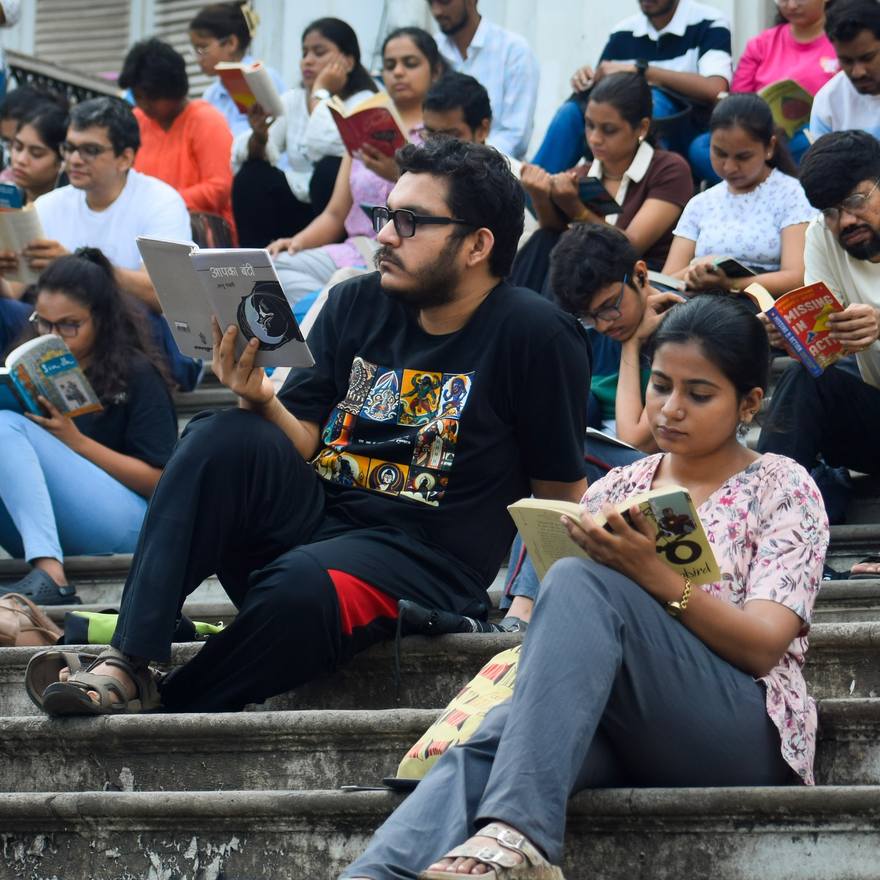 Readers seated together on stone steps