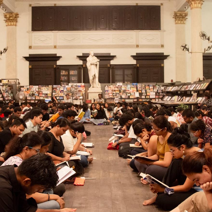Readers filling a grand columned hall