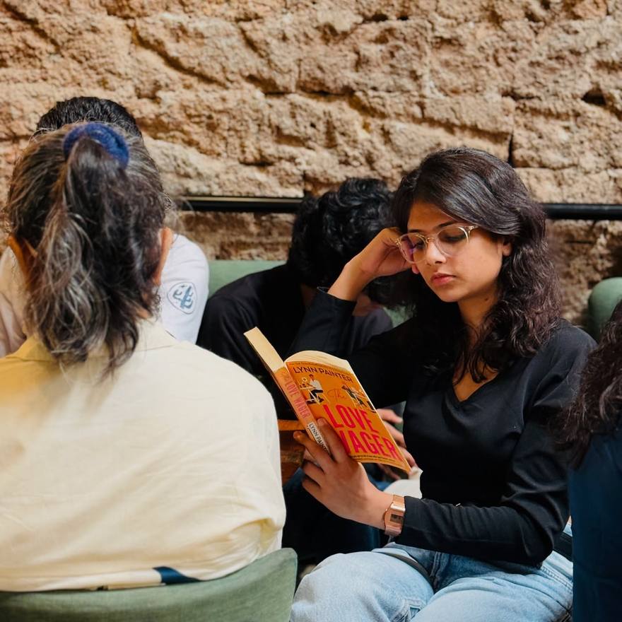 Readers against an old stone wall