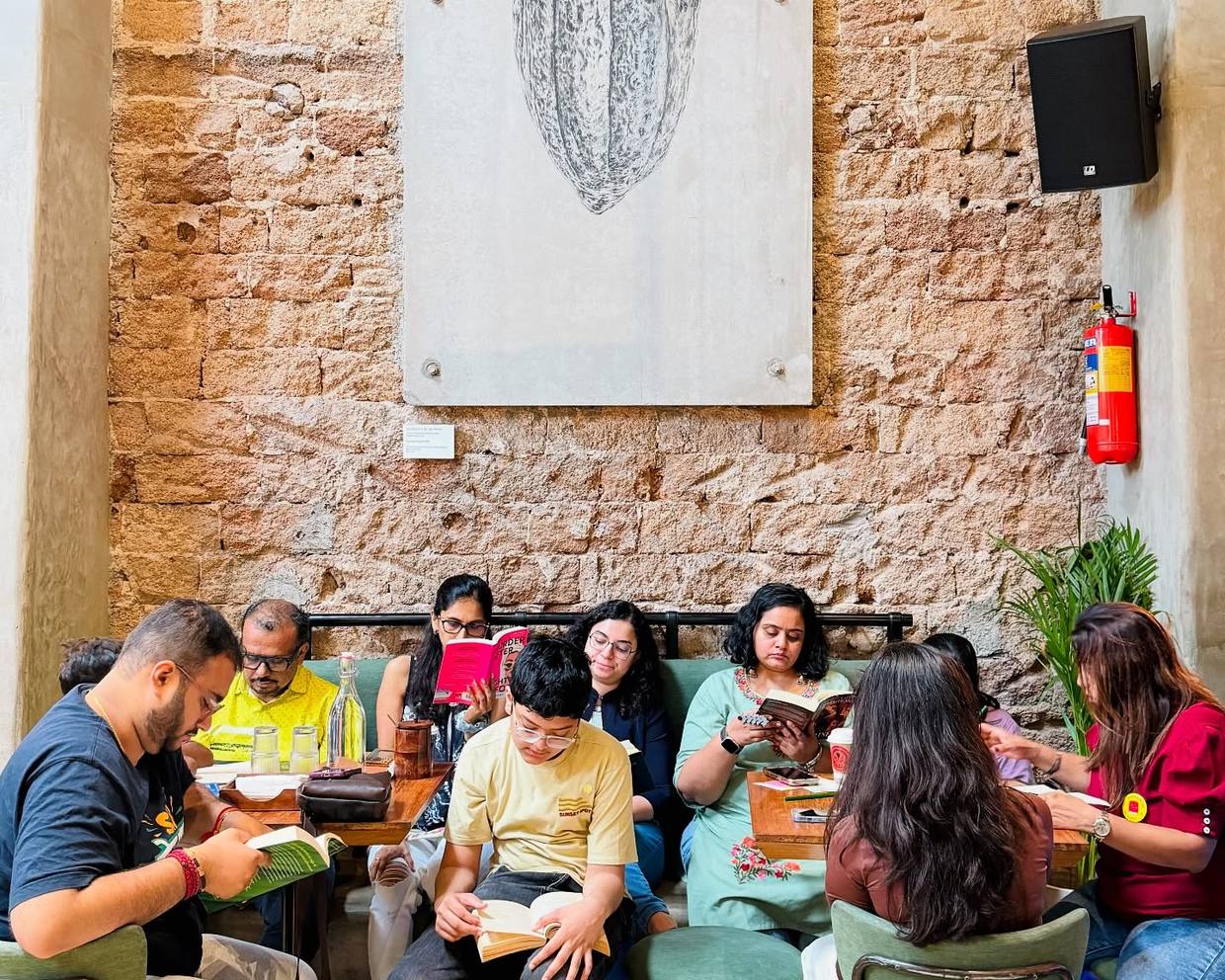 Readers seated inside a stone industrial interior